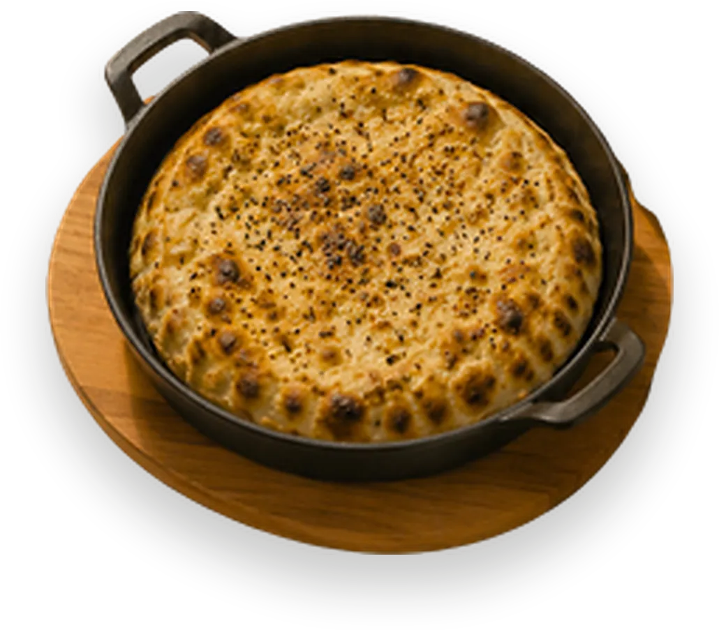 Slow-cooked beef under a golden cheese dome in a cast-iron pan